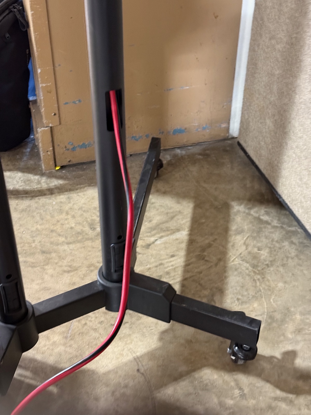 Extension cord routed through stand pole